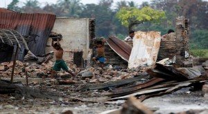 Children recycle goods from the ruins of a market which was set on fire at a Rohingya village outside Maugndaw in Rakhine state, Myanmar, October 27, 2016. REUTERS/Soe Zeya Tun/Files