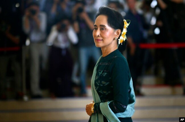 FILE - National League for Democracy party (NLD) leader Aung San Suu Kyi arrives in Myanmar's parliament in Naypyitaw, March 15, 2016.