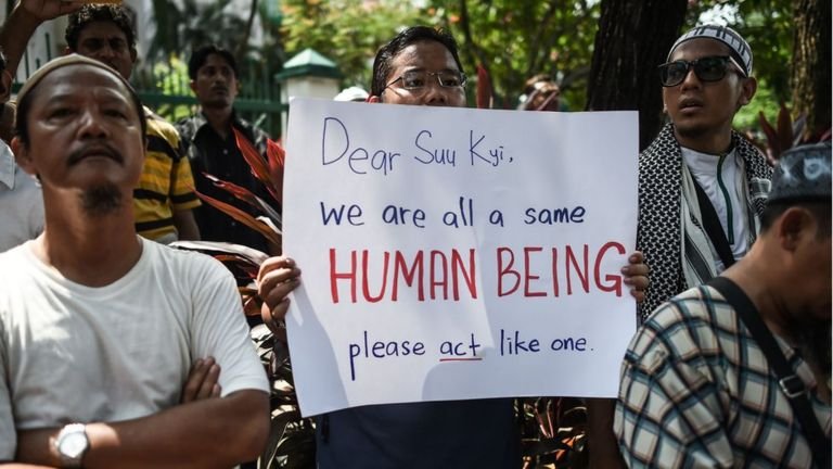 A protestor displays a placard during a protest against the persecution of Rohingya Muslims in Myanmar, outside the Myanmar embassy in Kuala Lumpur on 15 July 2016.