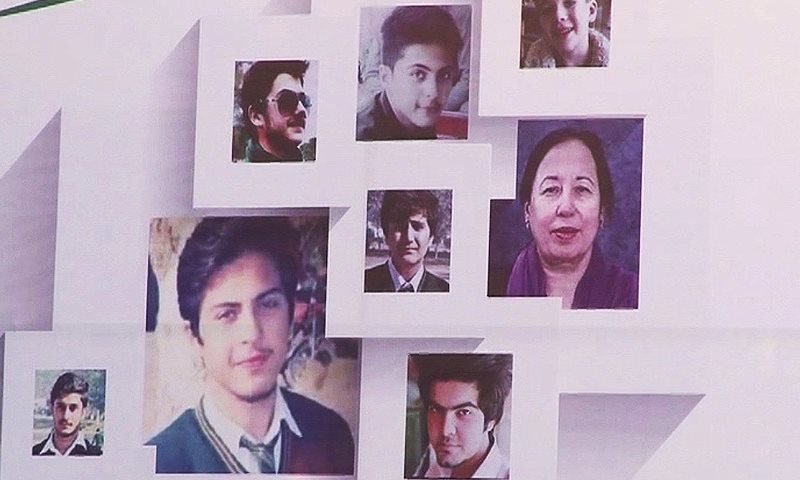 Photos of APS victims mounted on a board in Lahore to commemorate the attack.— DawnNews screengrab