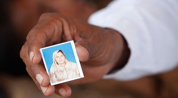 Muhammed Iqbal, 45, shows a picture of his late wife Farzana Iqbal, at his residence in a village in Moza Sial, west of Lahore, May 30, 2014. — Photo by Reuters Muhammed Iqbal, 45, shows a picture of his late wife Farzana Iqbal, at his residence in a village in Moza Sial, west of Lahore, May 30, 2014. — Reuters 