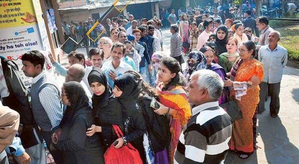 People wait in queues to exchange money in Moradabad on Friday. Methods such as bulk buying of train tickets and cancelling them for a refund are being used to get rid of old currency.. PTI Photo