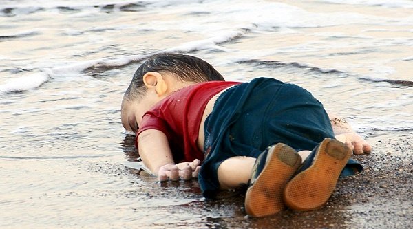 Young Syrian toddler identified as Aylan Kurdi, who drowned in a failed attempt to sail to the Greek island of Kos, lies on the shore in the Turkish coastal town of Bodrum, Turkey, September 2, 2015. The image went viral and shocked the world bringing home the seriousness of refugee crisis on Europe's shores.  At least 11 migrants believed to be Syrians drowned as two boats sank after leaving southwest Turkey for the Greek island of Kos.  Reuters/Nilufer Demir/DHA