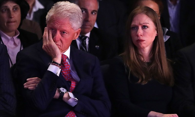 Husband and former US President Bill Clinton and daughter, Chelsea Clinton listen as Democratic presidential nominee Hillary Clinton speaks during the Presidential Debate .— AFP