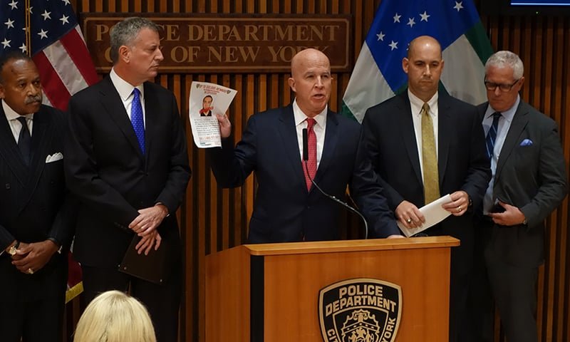 NYPD Police Commissioner James O'Neill holds up a picture of Ahmad Kahn Rahami on Sept 19, with the text 'Apprehended' written on it, — AFP