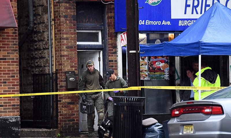 FBI officers and canine unit check the family restaurant and adjoined apartment of Ahmad Khan Rahami in Elizbeth, New Jersey.— AFP