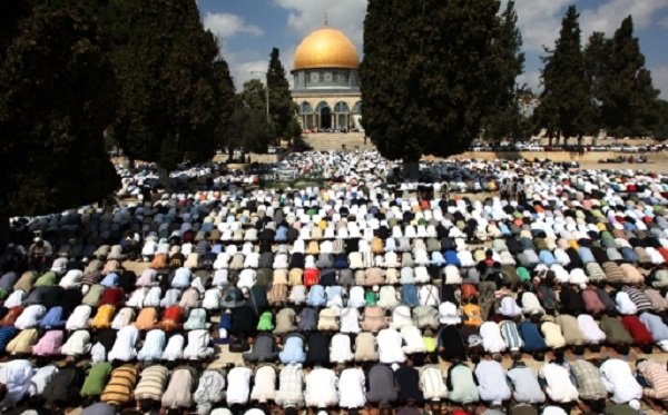 Palestinian worshipers pray outside the Dome of the Rock at the Al-Aqsa mosque in Jerusalem, the third holiest shrine of Islam.  AFP file photo by Ahmad Gharabli