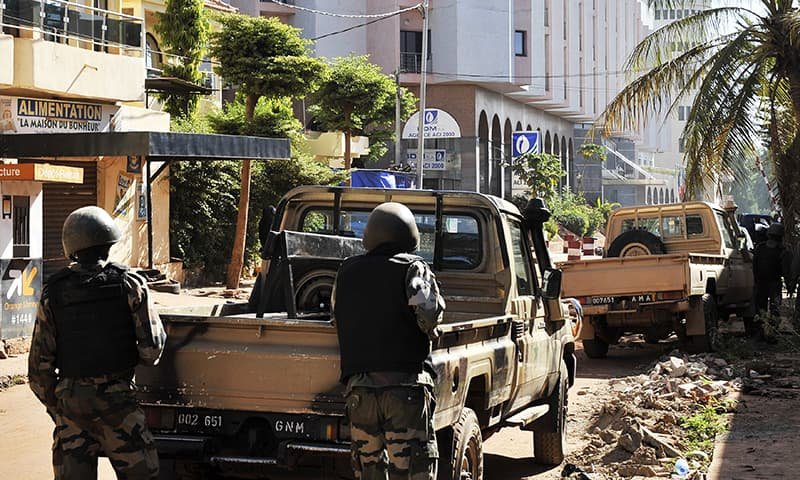 Malian troops take position near the Radisson Blu hotel in Bamako. -AFP