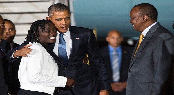 PHOTO: Kenyan President Uhuru Kenyatta, right, watches as President Barack Obama, center, hugs his half-sister Auma Obama, left, after he arrived at Kenyatta International Airport on July 24, 2015 in Nairobi, Kenya.