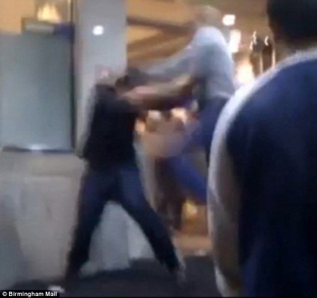 The man in the light grey top punches and kicks the man in quick succession as he tries to defend himself