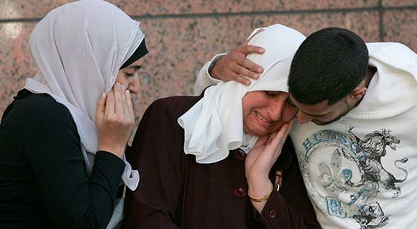 Zolfa Elaydi, center, with her children Fidaa, left, and Jihad, reacting to news that the leaders of Al Harmain Foundation had been convicted in Dallas. AP photo