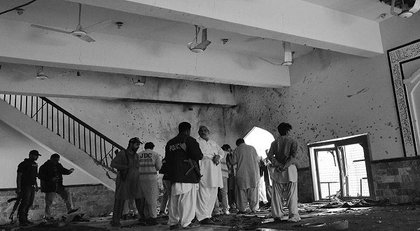 Pakistani security officials and police examine the scene following a bomb attack at a Shiite Muslim mosque in Shikarpur in Sindh province, some 470 kilometres north of Karachi on January 30, 2015. A bomb tore through a busy Shiite mosque in southern Pakistan on January 30 killing at least 20 people, officials said, in the deadliest sectarian attack to hit the country in a year. AFP/Fida Hussain