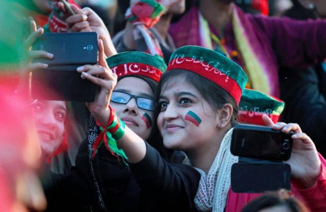 Young supporters of Imran Khan take their picture with a mobile phone during a Pakistan Tehreek-i-Insaf rally in Islamabad.