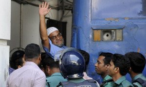 Jamaat-e-Islami leader Mir Quasem Ali waves his hand as he enters a van at the International Crimes Tribunal court in Dhaka in this file photo. —AFP/File