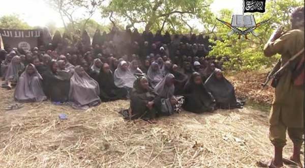 This May 12, 2014, file image taken from video by Nigeria's Boko Haram terrorist network, shows the girls abducted from the northeastern town of Chibok. In their latest atrocity, Boko Haram gunmen reportedly killed 48 fish vendors in Nigeria’s restive Borno State on Sunday. (AP Photo/File)