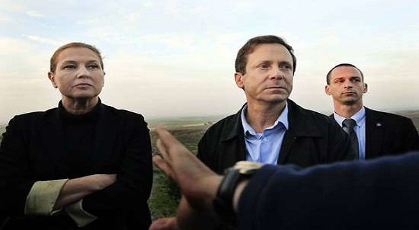 Israeli politicians Isaac Herzog, right, and Tzipi Livni listen during a tour along the Israel and Gaza Strip border on December 11. AP photo.