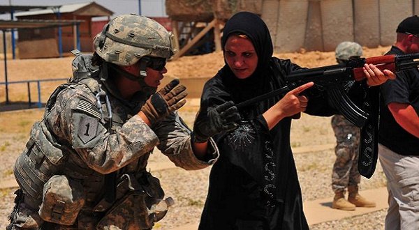 US Army Spc. Claudia Gallegos, left, with 855th Military Police Company, 317th Military Police Battalion, 49th Military Police Brigade, attached to 3rd Infantry Division, coaches a female Iraqi Police recruit on a range near Mosul, Iraq, July 9, 2010. UPI/Edward Reagan/US Army 