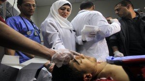 Palestinian doctors check the body of Saji Sayel Darwish, a Palestinian youth who was shot dead by Israeli forces on a road near the West Bank administrative capital Ramallah, at a hospital. AFP PHOTO / ABBAS MOMANI