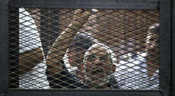 A file picture taken on June 7, 2014 shows Egyptian Muslim Brotherhood leader Mohamed Badie gesturing as he shouts from inside the defendants cage during his trial in Cairo. (AFP)