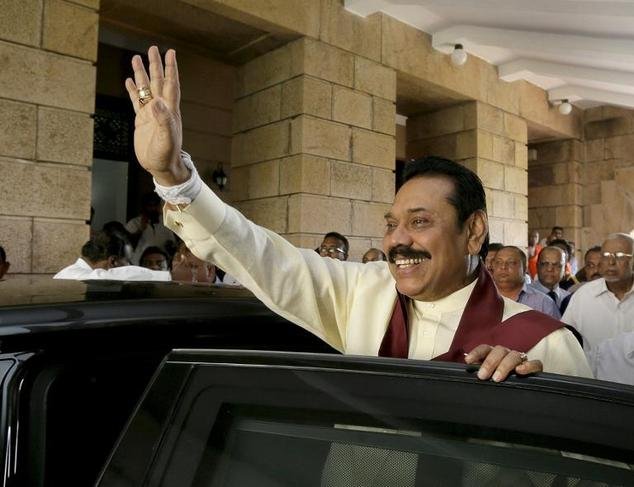 Sri Lanka's outgoing president Mahinda Rajapakse waves as he leaves his office in Colombo, on January 9, 2015