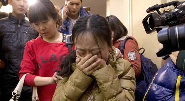 Families of passengers on the missing Malaysian Airlines plane react in Beijing.