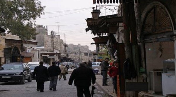 People walk along a street near Aleppo's historic citadel, in the Old City of Aleppo, Syria. Reuters