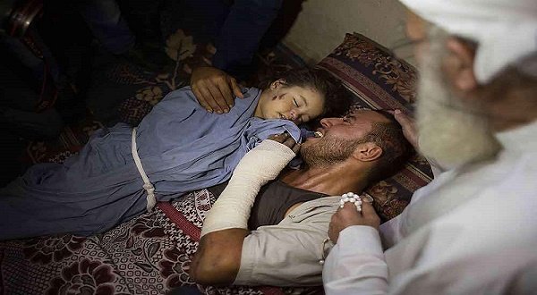 A Palestinian man cries next to his baby who was killed with his pregnant wife in an Israeli airstrike on Gaza this week. AP