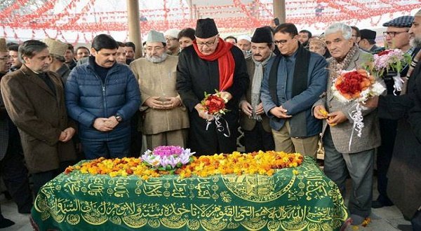 Srinagar: National Conference President Farooq Abdullah along with his party leaders paying floral tribute at the mausoleum of his father & founder of National Conference, Sheikh Mohammad Abdullah on his 111th birth Anniversary,at Naseem bagh in Srinagar