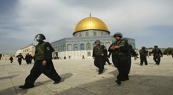 Israeli troops walk past the Dome of the Rock at the al-Aqsa mosque compound in Jerusalem,. AP
