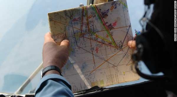 This picture taken aboard a Vietnamese Air Force helicopter shows a crew member checking a map during a search flight some 200 km over the southern Vietnamese waters off Vietnam's island Phu Quoc as part of continued efforts to trace the missing Malaysia Airlines MH370. Photo HOANG DINH NAM/AFP/Getty Images