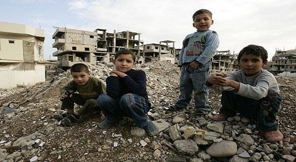 Palestinian children sit on a pile of dirt at the war-battered refugee camp of Nahr Al Bared.
