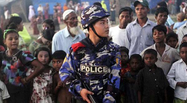 A policeman stands guard after attacks on a Rohingya refugee camp in Thandwe Myanmar. AP