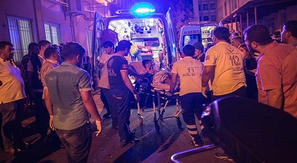 First aid officers carry injured man to hospital after an attack on a wedding party in Turkey.