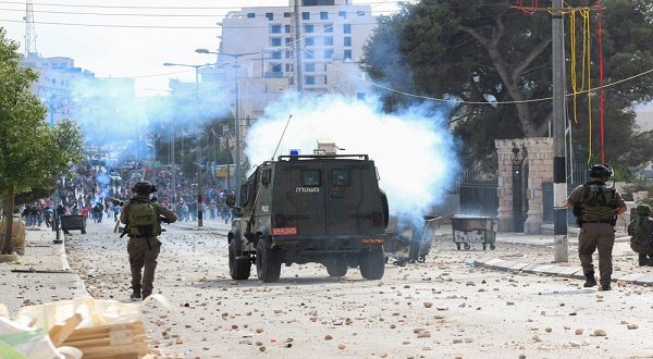 Israeli forces take on Palestinian youths in the West Bank town of Bethlehem on 6 October. Muhannad Saleem ActiveStills