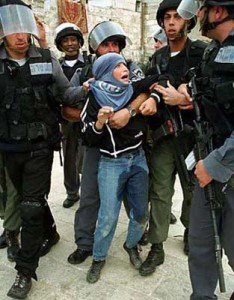 Israeli soldiers and "border police" arresting a  terrified Palestinian child. Hundreds of children are in Israeli jails.