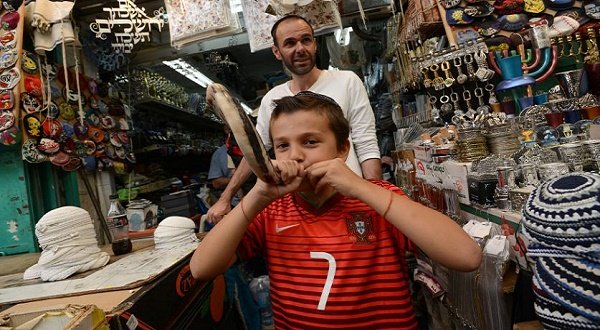 An Israeli boy blows a shofar, a ram's horn, in a shop in the Mahane Yehuda market in Jerusalem, Israel, September 24, 2014. UPI/Debbie Hill Read more: http://www.upi.com/Top_News/World-News/2014/09/24/Rosh-Hashanah-celebrated-globally-as-Jews-usher-in-the-Hebrew-New-Year/7551411587454/#ixzz3EQTRdRCC