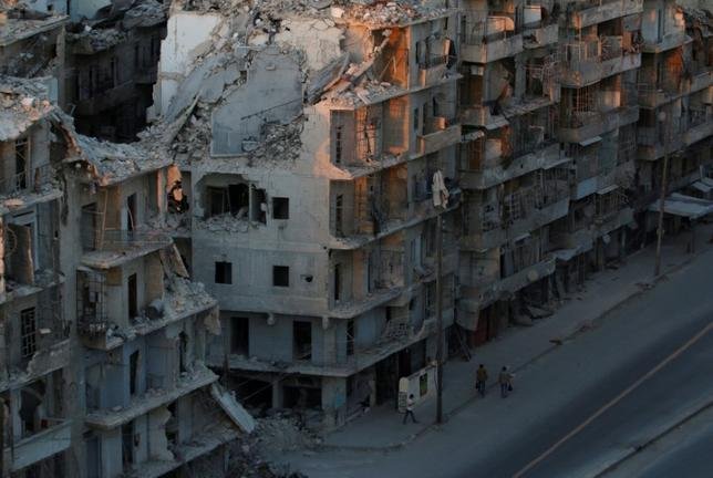 People walk past damaged buildings in the rebel-held Tariq al-Bab neighbourhood of Aleppo, Syria, October 5, 2016. REUTERS/Abdalrhman Ismail