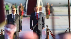Iraqi Prime Minister Haider al-Abadi (L) is welcomed by Jordan's King Abdullah II (R) with an official ceremony at Queen Alia International Airport, as part of the 28th Arab League Summit in Amman.