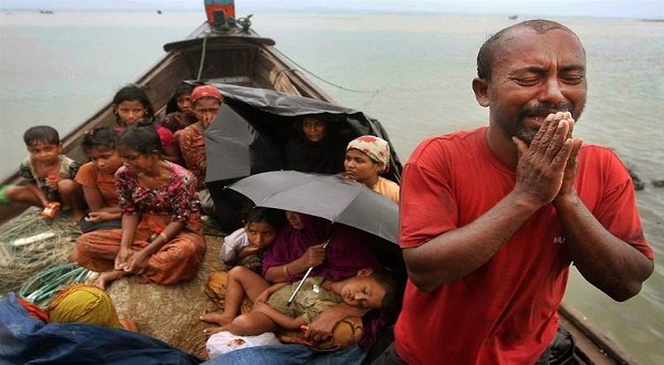 A Rohingya Muslim man who fled Myanmar to Bangladesh to escape religious violence cries as he pleads from a boat after he and others were intercepted by Bangladeshi border authorities in Taknaf, Bangladesh, June 13, 2014. Thousands of Rohingyas have fled Myanmar by boats to escape persecution and victimization. Photo by Anurup Titu / AP