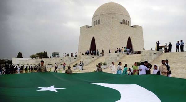 Pakistani students carry a giant national flag at the mausoleum of the founder of Pakistan Muhammad Ali Jinnah during a ceremony to mark the country's Independence Day in Karachi on August 14, 2012.