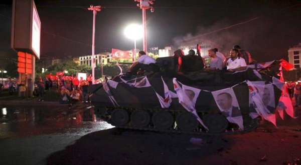 Supporters of Turkish President Tayyip Erdogan sit atop an armored vehicle decorated with Erdogan's portraits in Ankara, Turkey July 16, 2016. REUTERS/Tumay Berkin