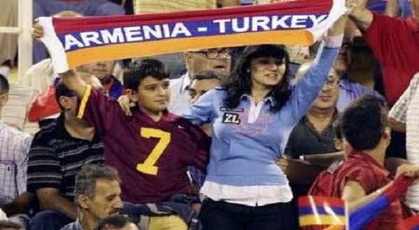 Turkish and Armenian soccer fans cheer for the two sides during a match between the traditional rivals