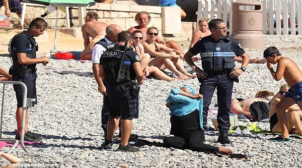 A woman on a beach was ordered to remove her garment. Photo courtesy Mail Online