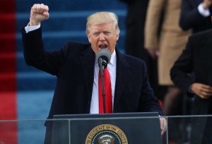 US President Donald Trump raises his fist after speaking during his Inauguration on January 20th in Washington DC. Image credit: New York Times