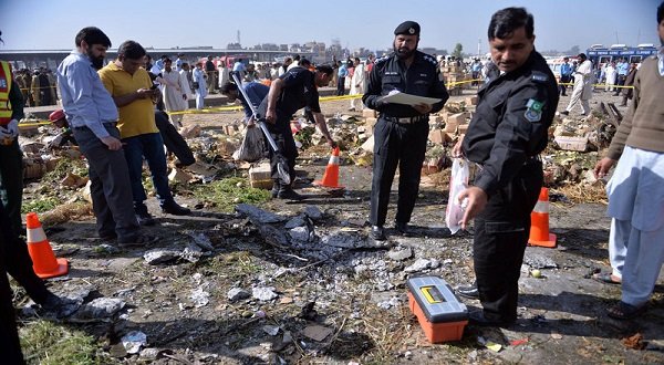 Pakistani security officials inspect the site of a bomb explosion in a fruit and vegetable market in Islamabad. AFP