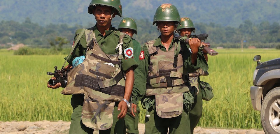 In this photograph taken on October 21, 2016, armed Myanmar soldiers patrol a village in Maungdaw located in Rakhine State as security operation continue following the October 9, 2016 attacks by armed militant Muslim. The United Nations called for an investigation into claims Myanmar troops have been killing civilians and torching villages in northern Rakhine, as reports emerged thousands of Rohingya had been forced from their homes. / AFP / STR (Photo credit should read STR/AFP/Getty Images)