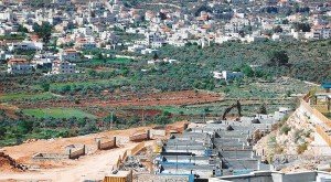 The Palestinian West Bank village of Turmus Ayya and houses under construction in the Jewish settlement of Shilo in the Occupied West Bank between Ramallah and Nablus. -- AFP