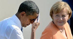 President Barack Obama wipes his brow as he and German Chancellor Angela Merkel leave the stage after his speech at the Brandenburg Gate in Berlin earlier this year..-AFP