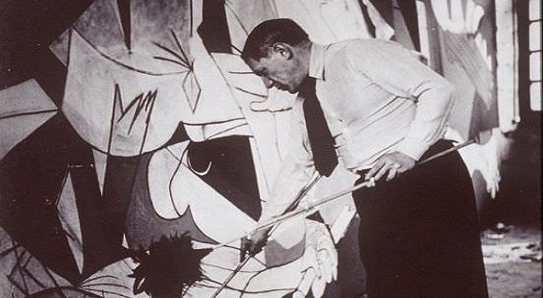 The master Pablo Picasso working on his masterpiece, Guernica.