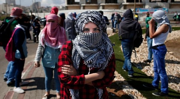 Young Palestinian women have increasingly joined males to hurl rocks at Israeli soldiers and chant slogans as unrest has spread in recent days in the occupied West Bank (AFP Photo/Thomas Coex)